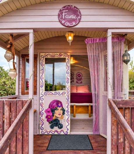 Bohemian Gypsy Wagon at Mammaloe’s Aruba with purple wooden exterior and pink door